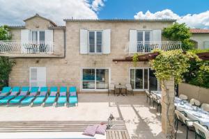 a villa with a swimming pool and a patio at Luxury Beachfront Villa Casa Mare with private heated pool and gym right at the beach in Mirca - Brac in Supetar