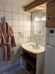 a bathroom with a sink and a mirror at Appartement de Charme in La Plagne Tarentaise