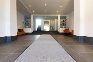a hallway of a building with two potted plants at NEU - MoselAUSZEIT Traben in Traben-Trarbach