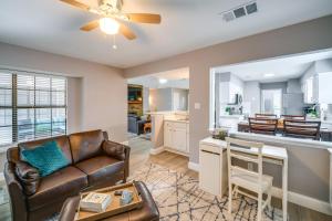 a living room with a couch and a kitchen at Cozy Carrollton Cottage with Fire Pit and Gas Grill! in Carrollton