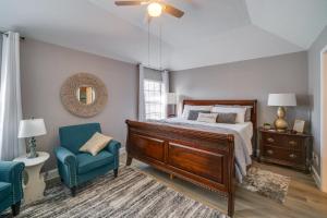 a bedroom with a bed and a chair and a mirror at Cozy Carrollton Cottage with Fire Pit and Gas Grill! in Carrollton