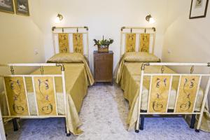 Ліжко або ліжка в номері Il Falconiere