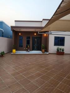 a house with a tiled floor and a patio at THE OPULENT OASIS in Accra