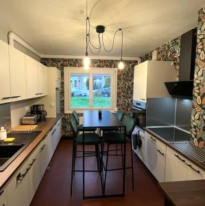 a kitchen with a table and chairs in it at Traezh ar vag - Appartement Plage Perros-Guirec in Perros-Guirec