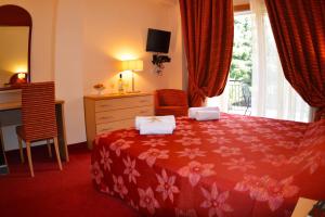 a bedroom with a bed and a dresser and a window at Petros Italos in Neos Marmaras