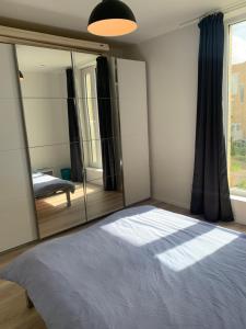 una camera con un letto e un grande specchio di Private Room in Shared House a Ostenda