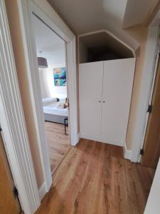 a hallway with a white cabinet and a bedroom at Apt in Stoneybatter D7 in Dublin