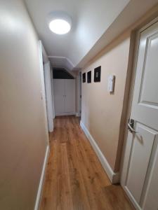 an empty hallway with a door and wooden floors at Apt in Stoneybatter D7 in Dublin