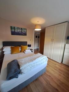 a bedroom with a large white bed with yellow pillows at Apt in Stoneybatter D7 in Dublin