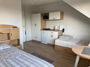 a small room with two beds and a table at Magdalena in Karwia