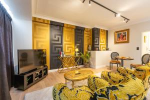 a living room with two couches and a tv at Appartement centrum 2 in Ostend