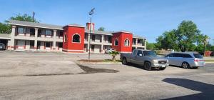two cars parked in a parking lot in front of a building at Econo Inn Lackland AFB-Seaworld San Antonio in San Antonio +1 photo