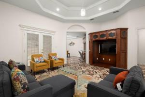 a living room with couches and a flat screen tv at Alton House in Alton