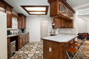 a kitchen with wooden cabinets and a counter top at Alton House in Alton