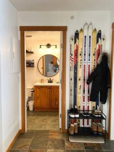 a room with a bunch of skis on the wall at TOP FLOOR at very Base of Hill w AC & Best Views on Mountain in Panorama