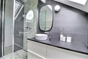 a bathroom with a sink and a mirror at Belle maison avec piscine à 30 min de Paris in Yerres