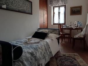 a bedroom with a bed and a table and a dining room at Bed And Breakfast Margherita in Gerano