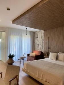 a bedroom with a large bed and a living room at VISEU EXECUTIVE Hotel in Viseu