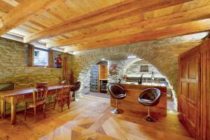 a dining room with a wooden table and chairs at Le Bourg Charmant - Fleur du Printemps in Arvier