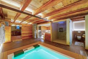 a bathroom with a swimming pool in a house at Le Bourg Charmant - Fleur du Printemps in Arvier +1 photo