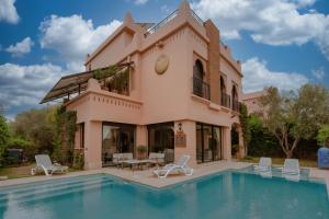 a house with a pool in front of it at Villa Nelya in Marrakech