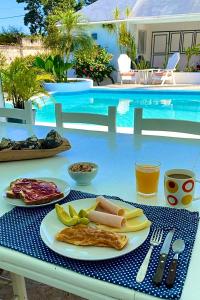 a plate of food on a table next to a pool at Villa Del Mar in Las Terrenas