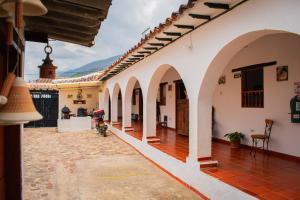 a courtyard of a house with a motorcycle parked in it at alojamiento JAW in Villa de Leyva