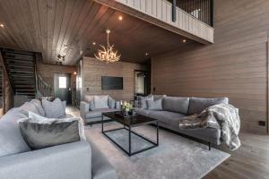 a living room with two couches and a tv at Idre Sky Mountain Lodge- Ski in Ski out in Idre