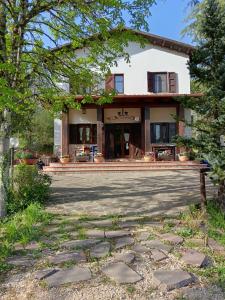 a house with a stone walkway in front of it at Bed And Breakfast Margherita in Gerano