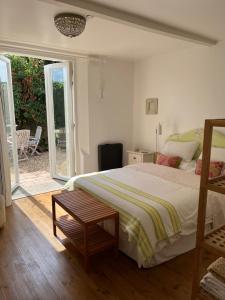 a bedroom with a bed and a table in it at La Petite Maison in Corme-Écluse