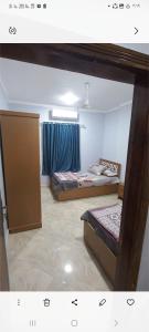 a room with two beds and a window at Ikea flat 8 in Hurghada