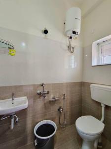 a bathroom with a toilet and a sink at Cozy 3 bhk A/C home @ wipro circle , Near US Embassy in Hyderabad
