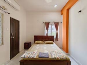a bedroom with a bed and a window at Cozy 3 bhk A/C home @ wipro circle , Near US Embassy in Hyderabad