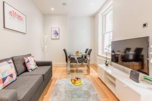 a living room with a couch and a table at Soho - Central London - CityApartmentStay in London