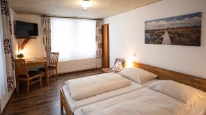 a bedroom with a bed and a desk and a desk at Hotel Royal in Monschau