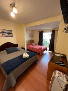 a bedroom with two beds and a television in it at Uli´s house in Lima