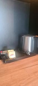 a counter top with a pot and a box on it at Czarna Perła Apartamenty Czarna Góra 103 in Sienna