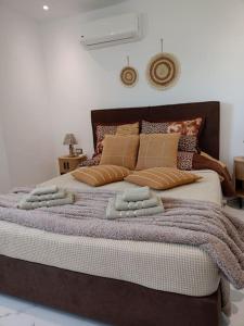 a bedroom with a large bed with three pillows at Blue Sky Villa in Kalithies
