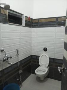 a bathroom with a toilet in a stall at HOTEL R K RESIDENCY MUZAFFARPUR in Muzaffarpur