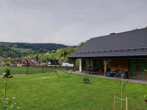 a house with a large yard in front of it at Domek na Duzynie in Ochotnica Górna