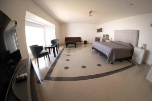 a bedroom with a bed and a table and chairs at Room in Guest room - 22 Suite for two people in Torreón