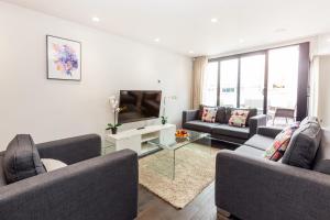 a living room with two couches and a television at Penthouse with Private Terrace Soho - CityApartmentStay in London