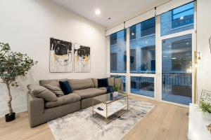 a living room with a couch and a glass table at Chic River North Condo 2BR 2BA with Private Balcony in Chicago