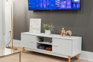 a white cabinet with a tv on a wall at Chic River North Condo 2BR 2BA with Private Balcony in Chicago +28 photos