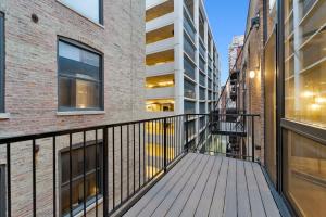 a balcony with a wooden walkway between two buildings at Chic River North Condo 2BR 2BA with Private Balcony in Chicago