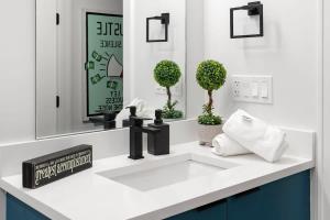 a bathroom with a white sink and a mirror at Chic River North Condo 2BR 2BA with Private Balcony in Chicago