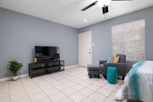 a living room with a bed and a tv at Oak Ridge 5 in McAllen