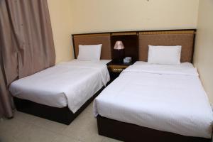 Postel nebo postele na pokoji v ubytování Dream Palace Hotel