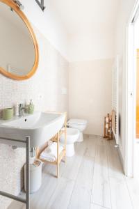 a bathroom with a sink and a toilet at Fabio Apartments San Gimignano in San Gimignano