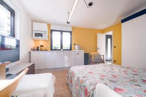 a large bedroom with a bed and a kitchen at Belle maison avec piscine à 30 min de Paris in Yerres